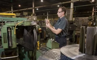 Employee Creating Metal Washers